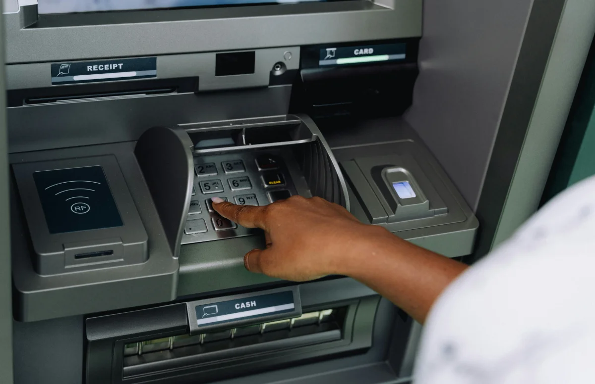 A customer withdrawing cash from an ATM
